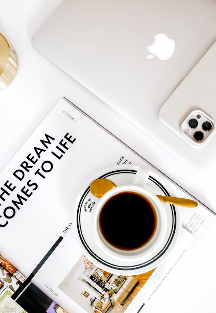 creative Top view of a modern workspace featuring coffee, a MacBook, and smartphone.